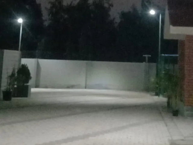 Rudhra solar street lights lighting a paved campus courtyard at night