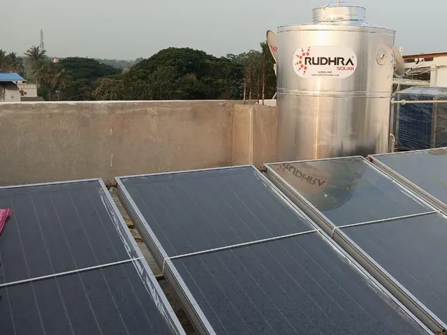 Rudhra Solar commercial collector array with a vertical stainless steel tank